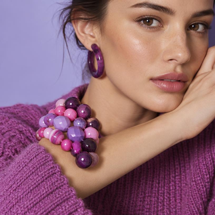 Stacked purple and pink beaded bracelets with matching hoops
