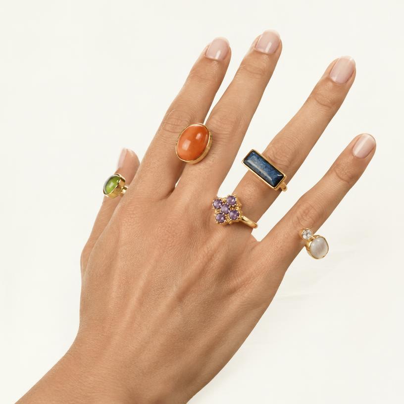 Mismatched colorful stone rings worn together