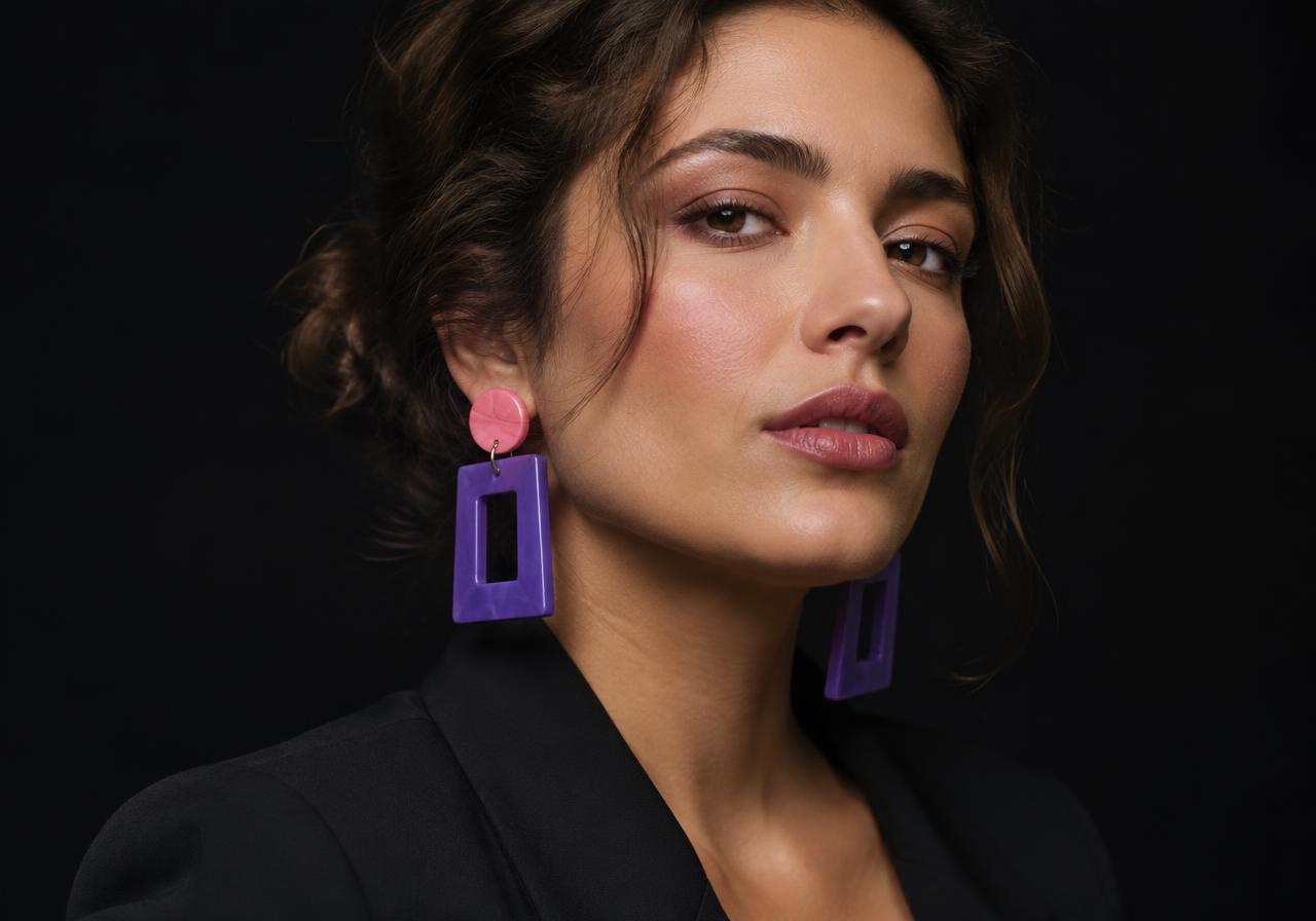 Woman wearing bold pink and purple geometric earrings